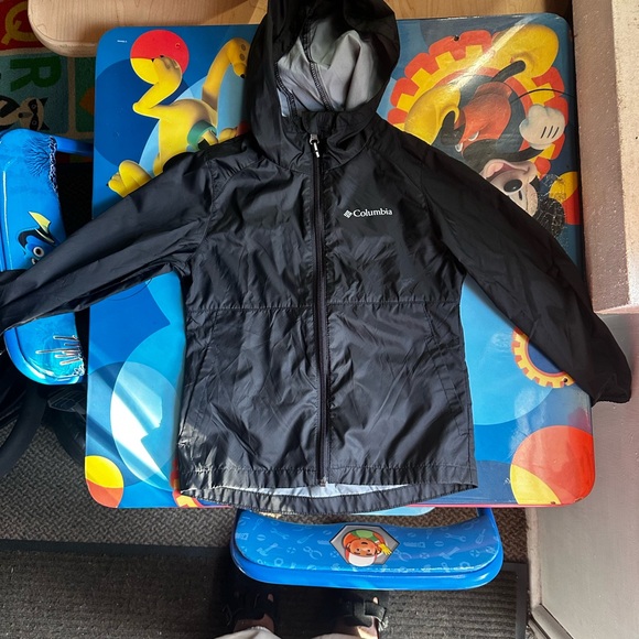 A Columbia rain jacket/wind breaker. It is black w/ a hood. No stains or tears. - Picture 3 of 4